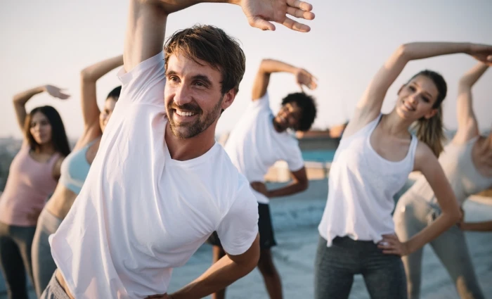 young man in outdoor yoga class