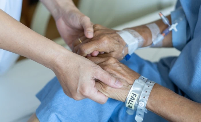 younger woman and older woman join hands